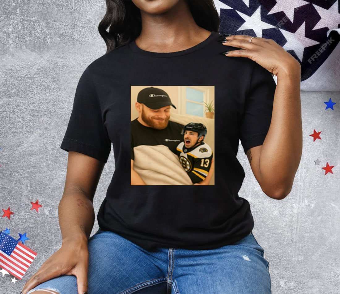 Sam Bennett Holding A Crying Marchand Tee Shirt