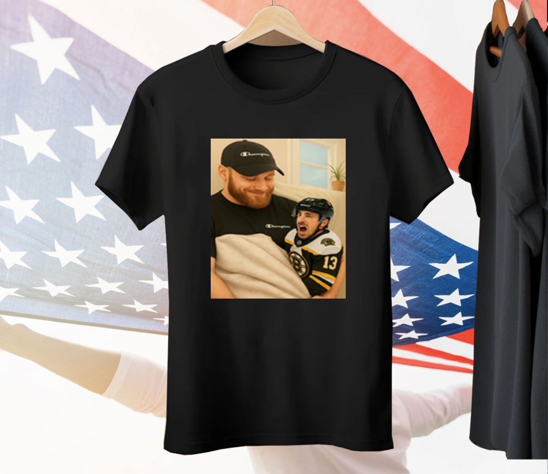Sam Bennett Holding A Crying Marchand Tee Shirt